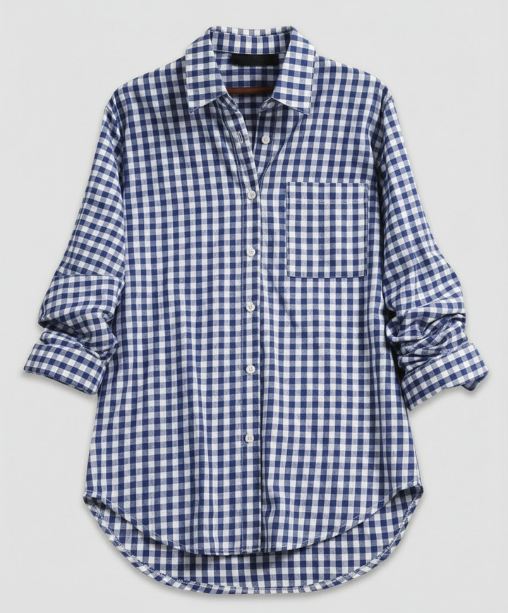 Woman in a classic plaid shirt layered over casual clothing against a plain background.