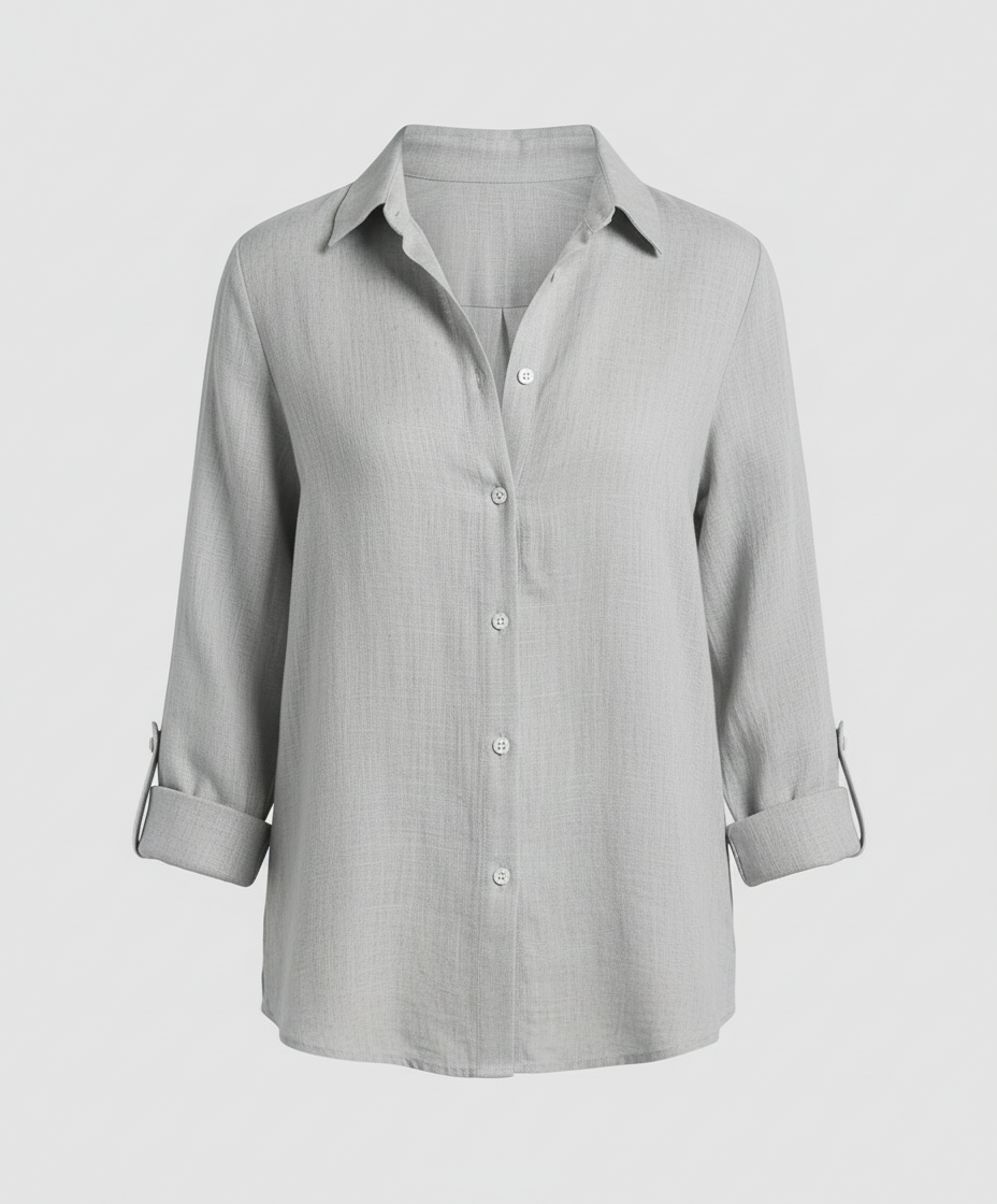Woman wearing a V-neck blouse designed for work and daily styling.
Female model in a stylish blouse with a flattering shape on a plain background.
