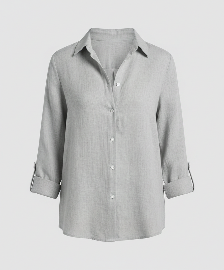 Woman wearing a V-neck blouse designed for work and daily styling.
Female model in a stylish blouse with a flattering shape on a plain background.
