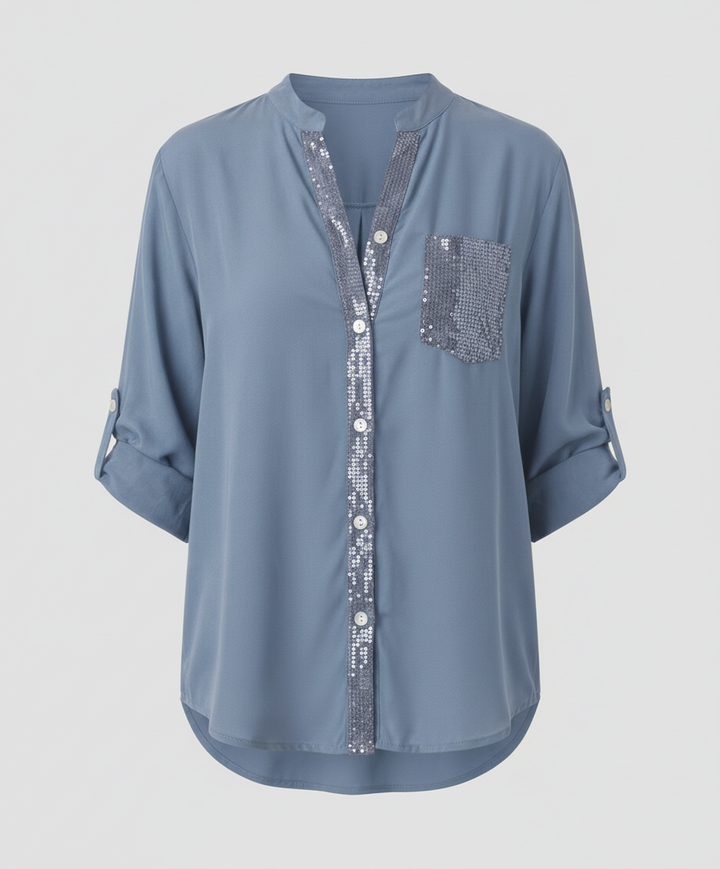 Lightweight blouse with a statement sequin pocket against a plain background