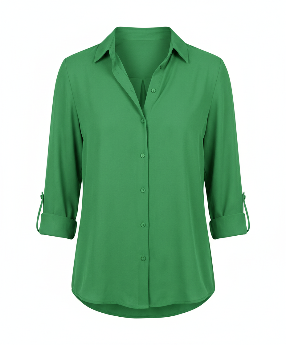 Woman in a versatile blouse with a timeless collar design on a plain backdrop.
