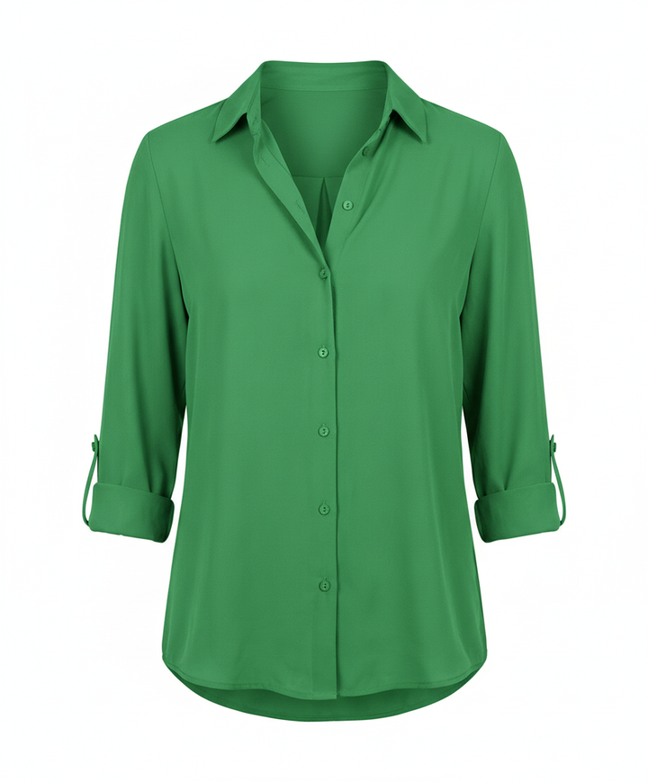 Woman in a versatile blouse with a timeless collar design on a plain backdrop.
