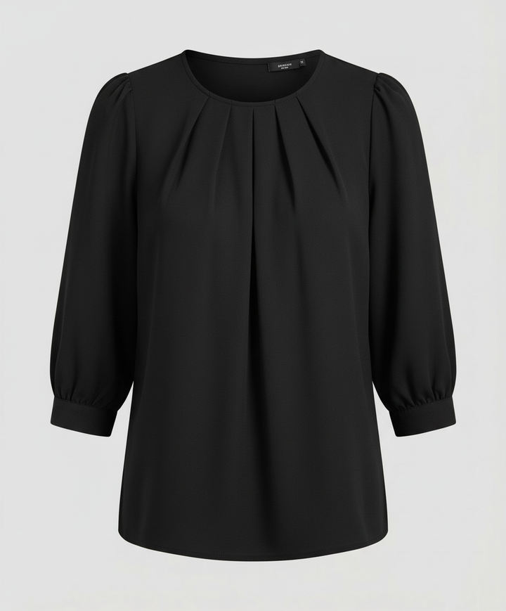Woman in an elegant satin blouse paired with a clean and polished look.
