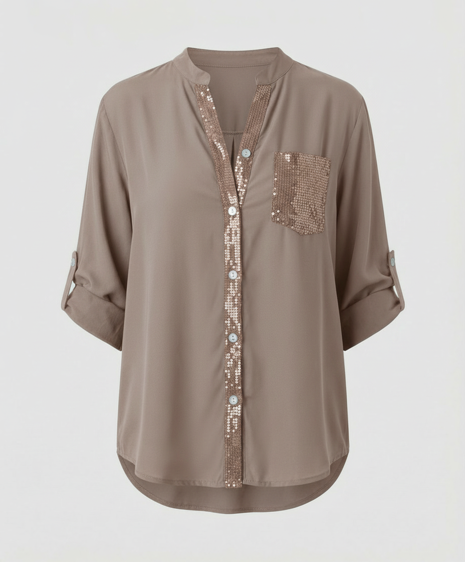 Loose blouse with eye-catching sequin detailing on the chest pocket.