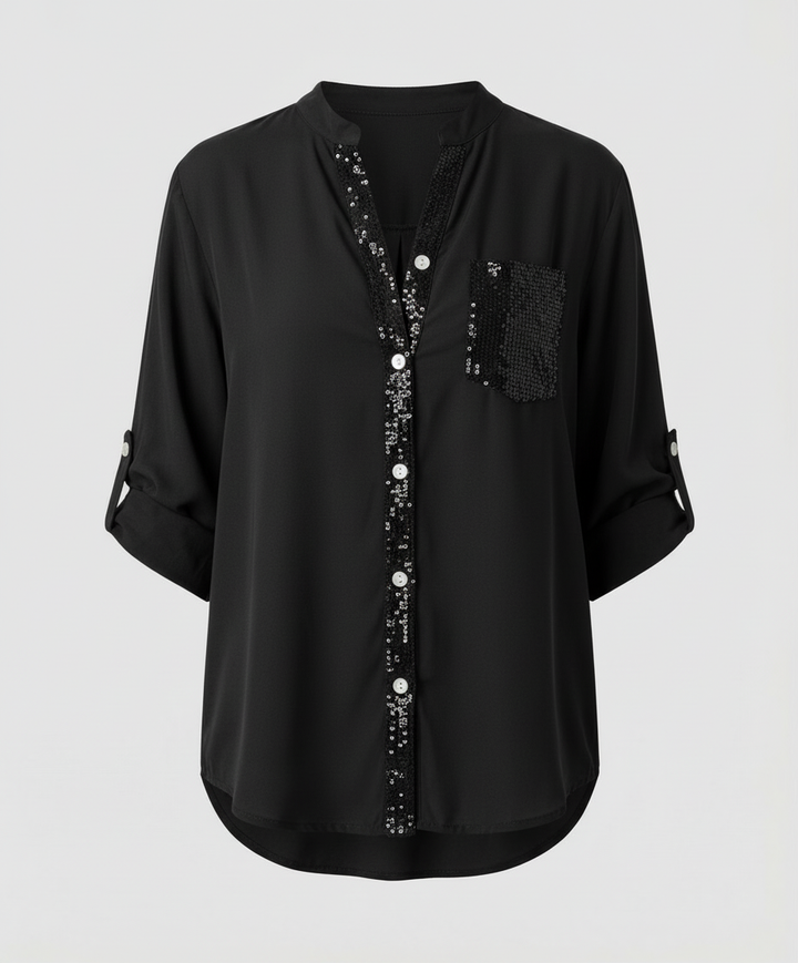 Loose-fitting blouse with a decorative sequin chest pocket.