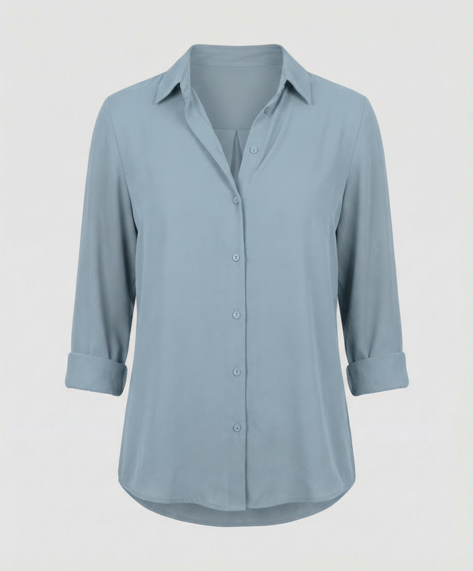 Female model in a classic ladies’ blouse with long sleeves against a plain background.
