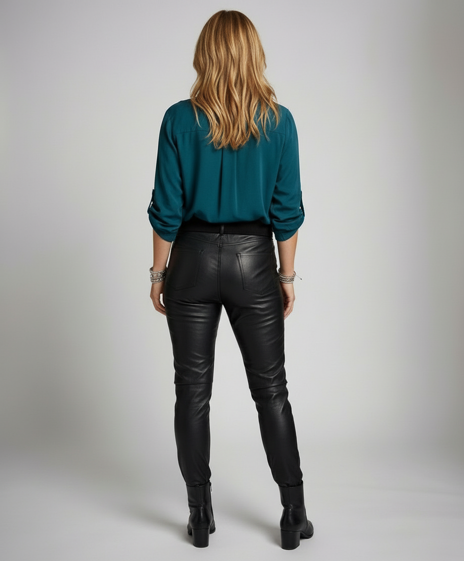 Female model showcasing a casual blouse with roll-up sleeves and a sequin pocket.