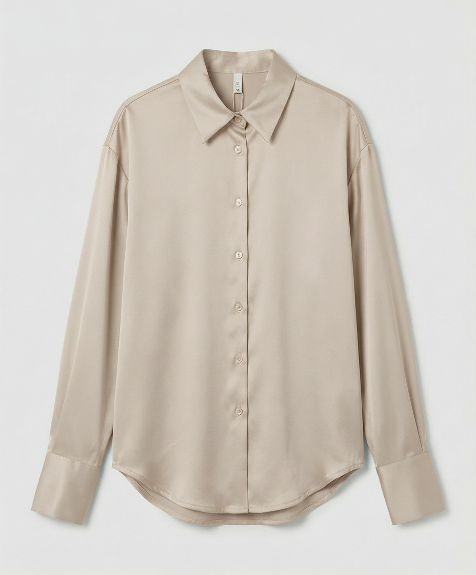 Silk blouse with graceful details on a plain background.