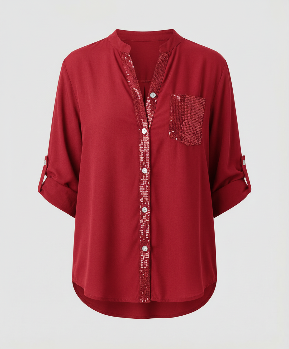 Casual blouse with a sparkling accent pocket against a plain backdrop.