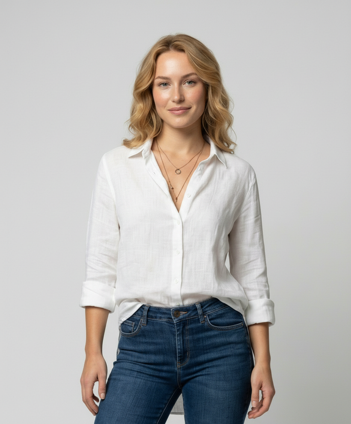 Female model wearing a V-neck blouse with a comfortable fit against a plain background.
