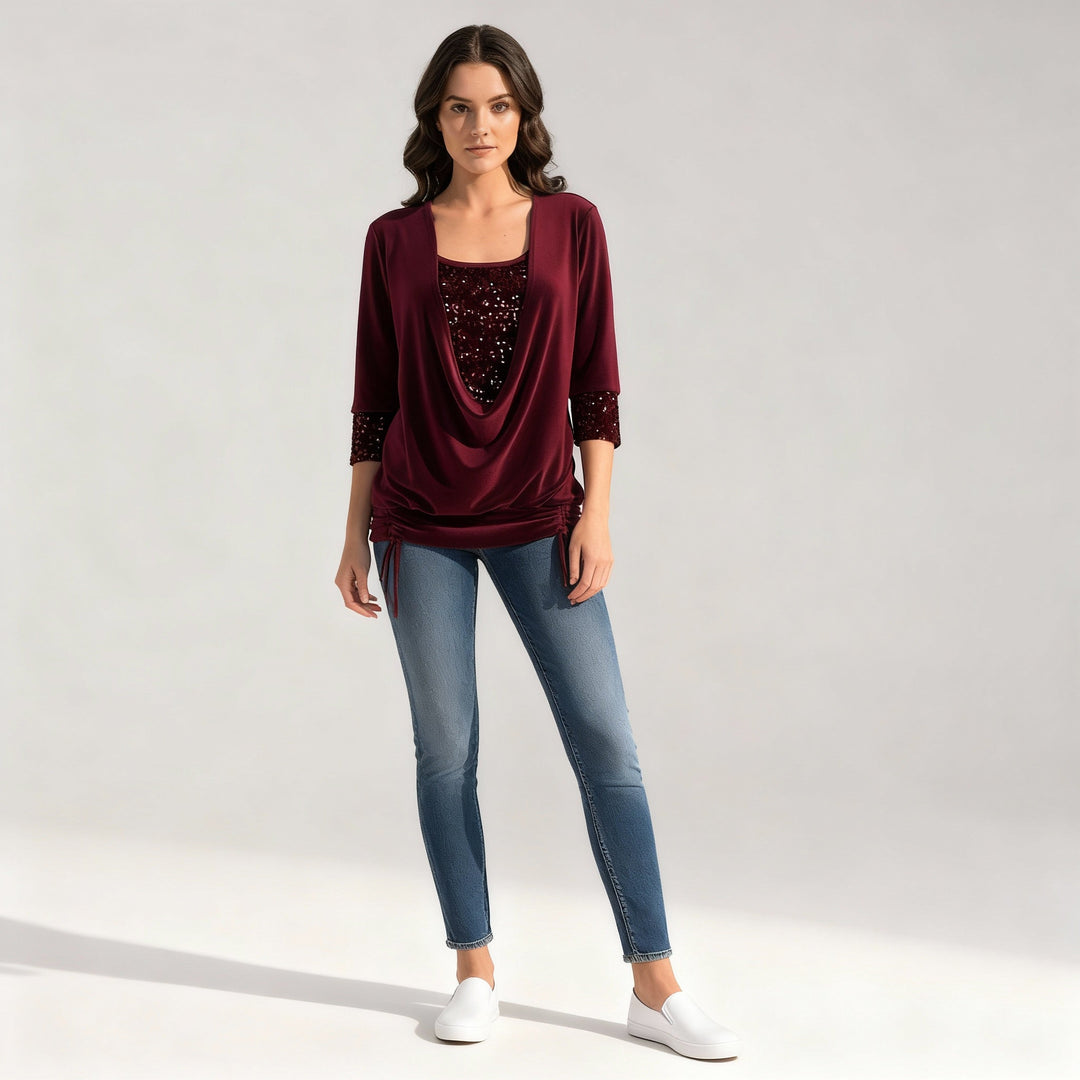 Female model in a solid color sequin blouse on a plain background.