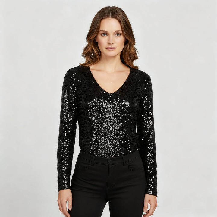 Female model wearing a glitter V-neck party top against a plain background.