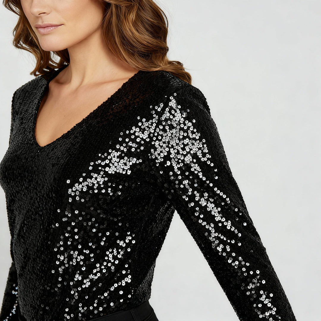 Female model showcasing a sparkling evening top with a flattering V-neck design.