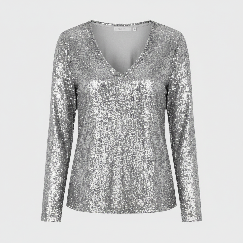 Woman in a sparkling party top paired with a simple plain backdrop.