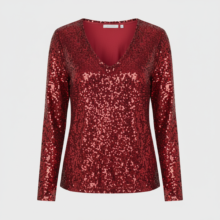 oman styled in a sparkling top for evening events against a plain background.
