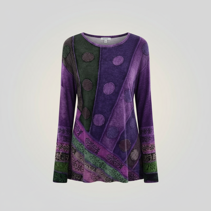 Female model showcasing a colourful casual tunic with an eye-catching vintage pattern.
