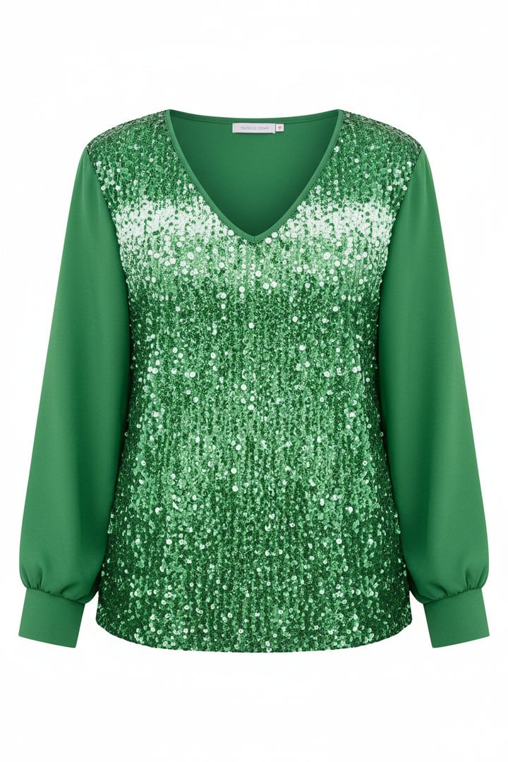 Female model in a V-neck blouse featuring understated sequin embellishments on a plain background.
