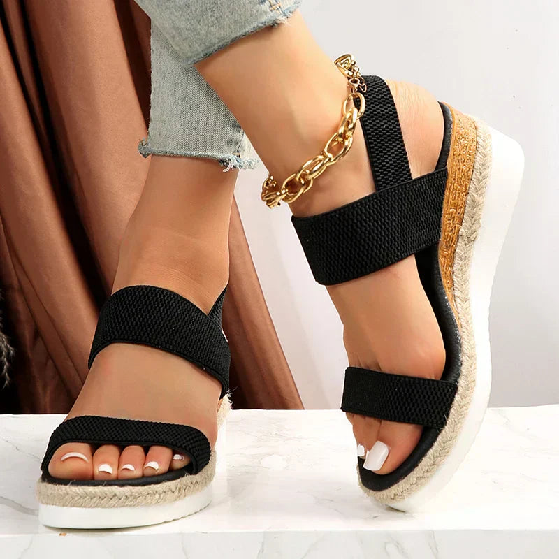 Model in summer sandals with white floor studio setting.