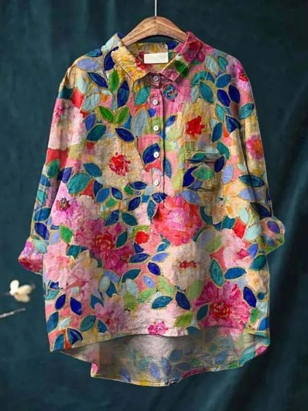 Women’s floral pocket blouse displayed on a clean background.