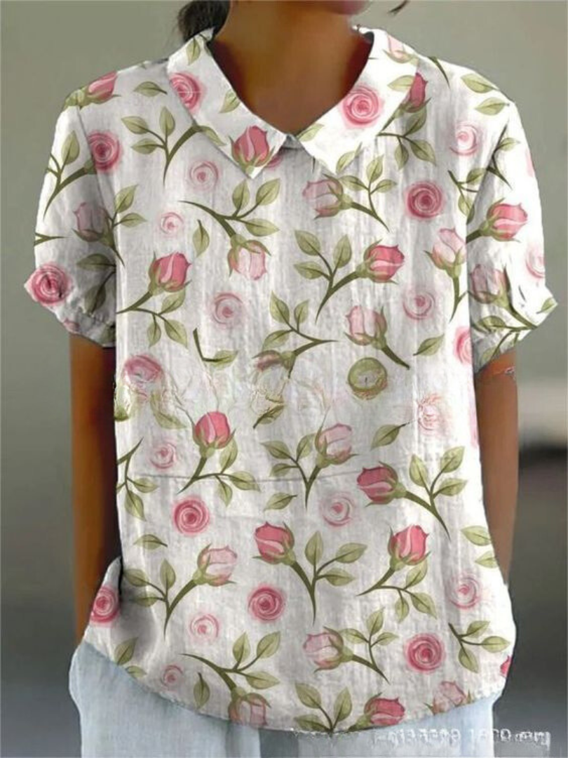  Woman wearing a floral print blouse designed for casual styling on a plain background.