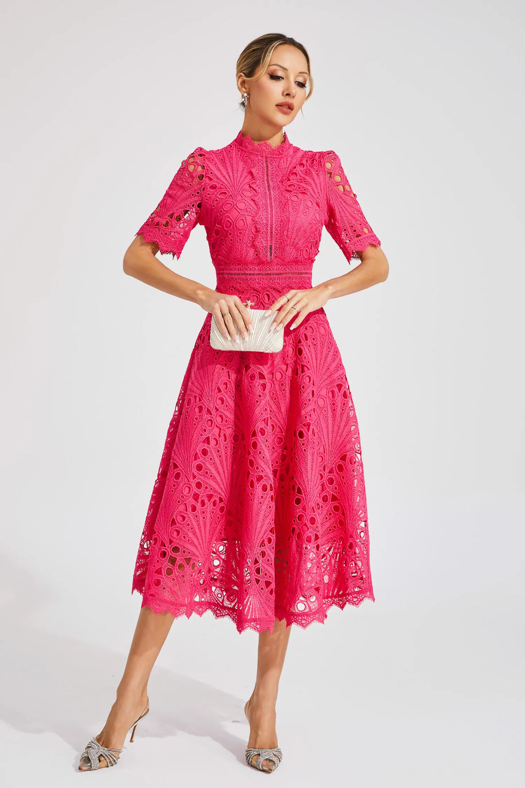 Woman model wearing a lace midi dress with A-line fit on a clean background.