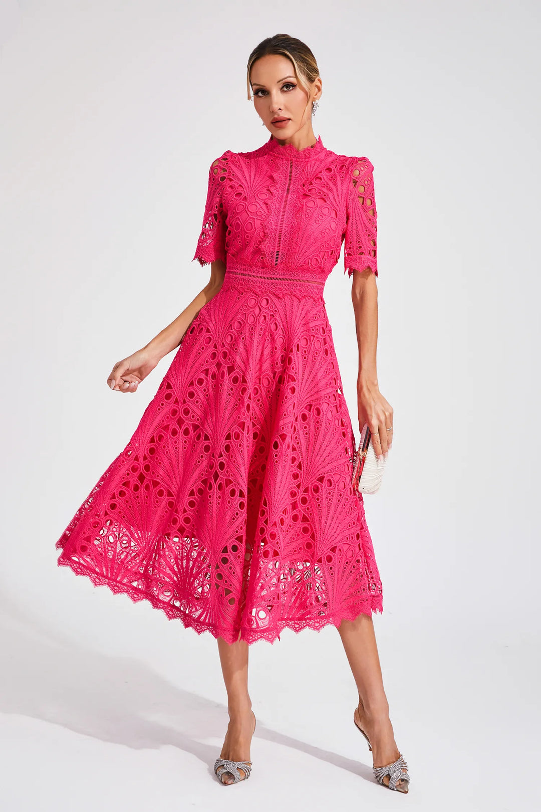 Elegant woman model showcasing a lace fit and flare midi dress against a plain background.