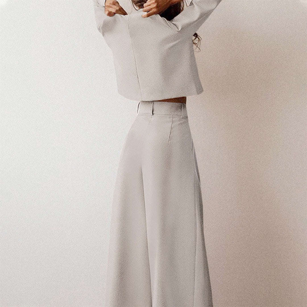 Woman standing in a stylish cropped top and loose-fit pa