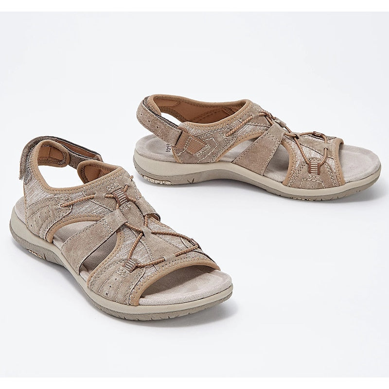 Top down sandals on feet plain background showcasing open design