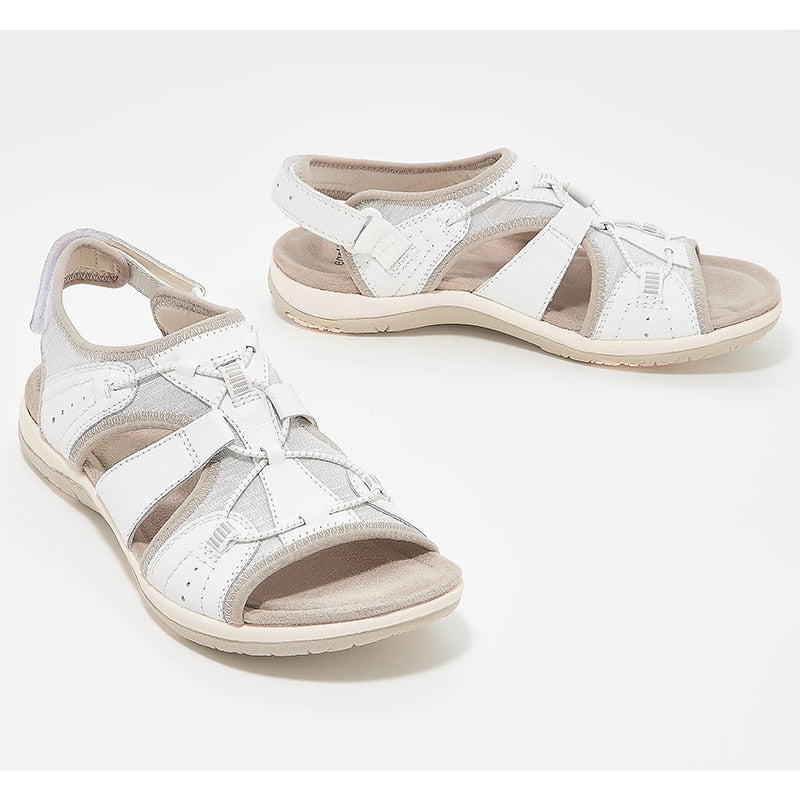 Close view arch support sandals on feet plain background detail