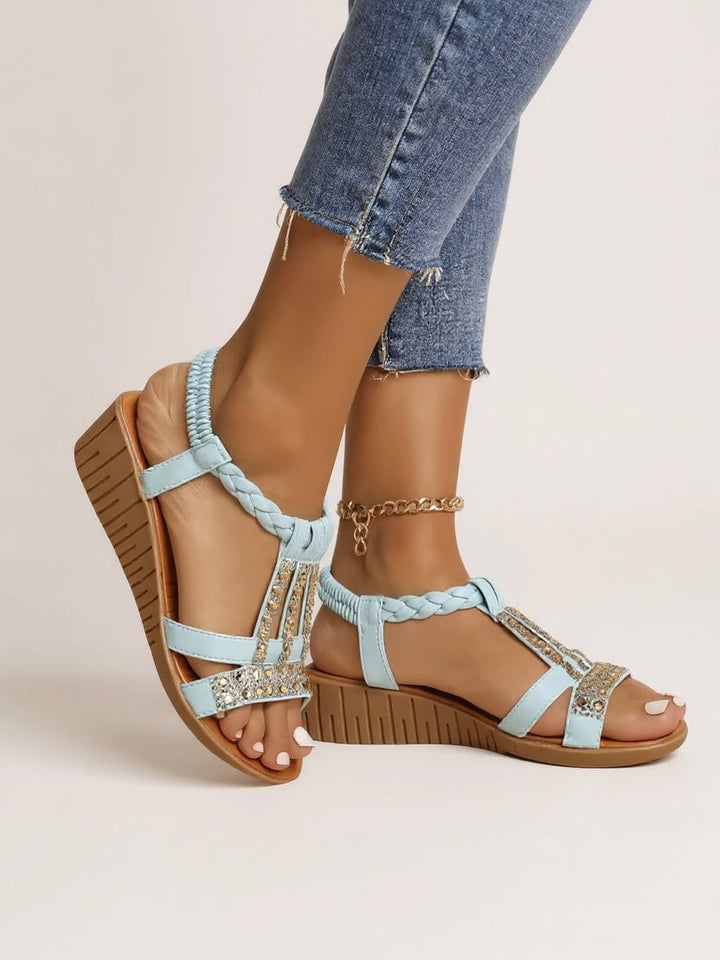 Elegant women’s wedge sandals shown on a model with a clean background.
