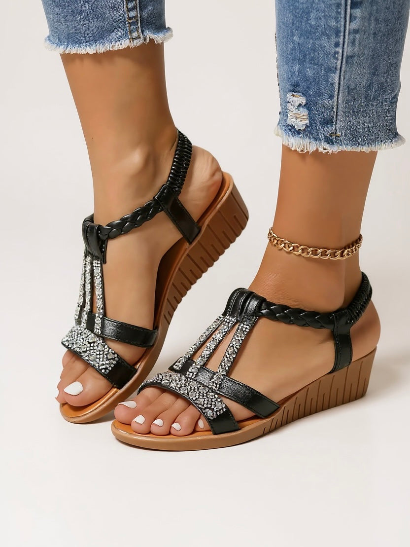 Chic embellished women’s sandals displayed on a model against a plain background.