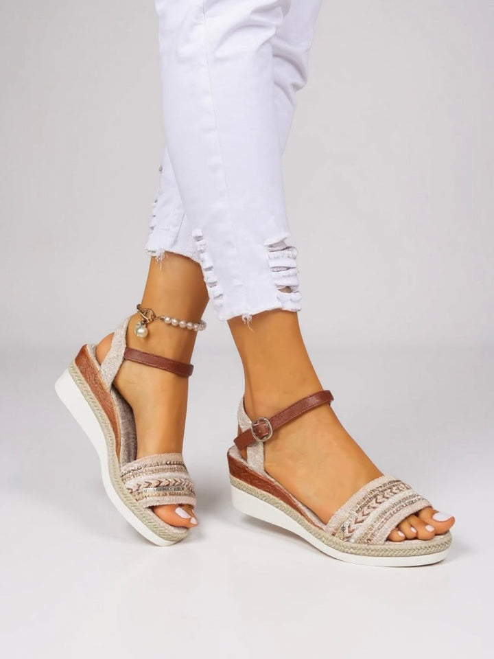 Sparkling embellished sandals styled on a model against a plain background.