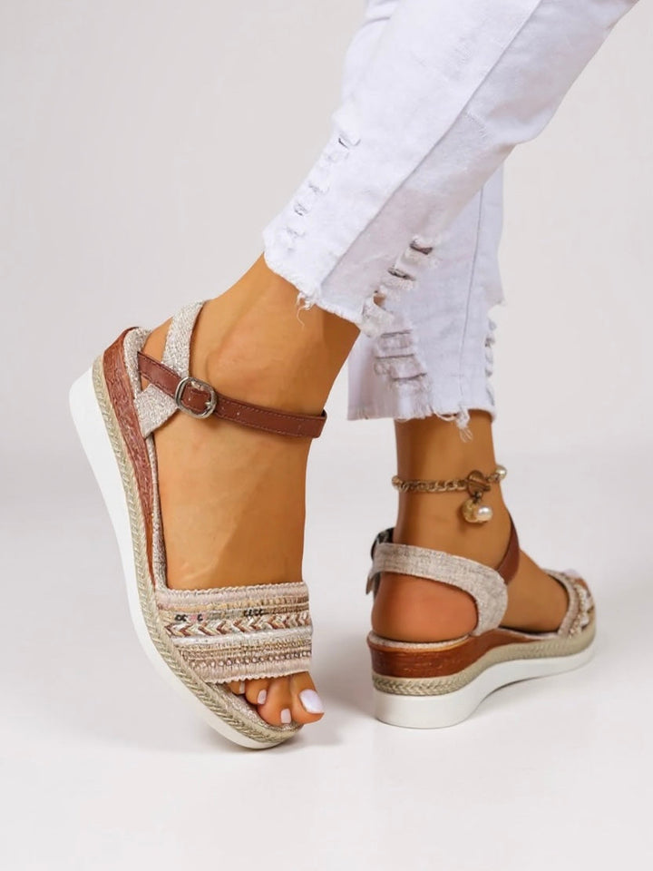 Embellished wedge sandals displayed on a model against a plain background.