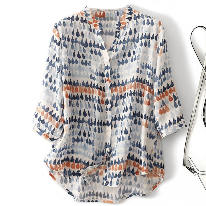 Lightweight abstract print button down blouse displayed on a model against a plain background.