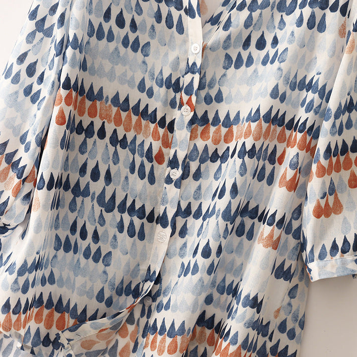Lightweight everyday blouse with modern print displayed on a model in a plain background setting.