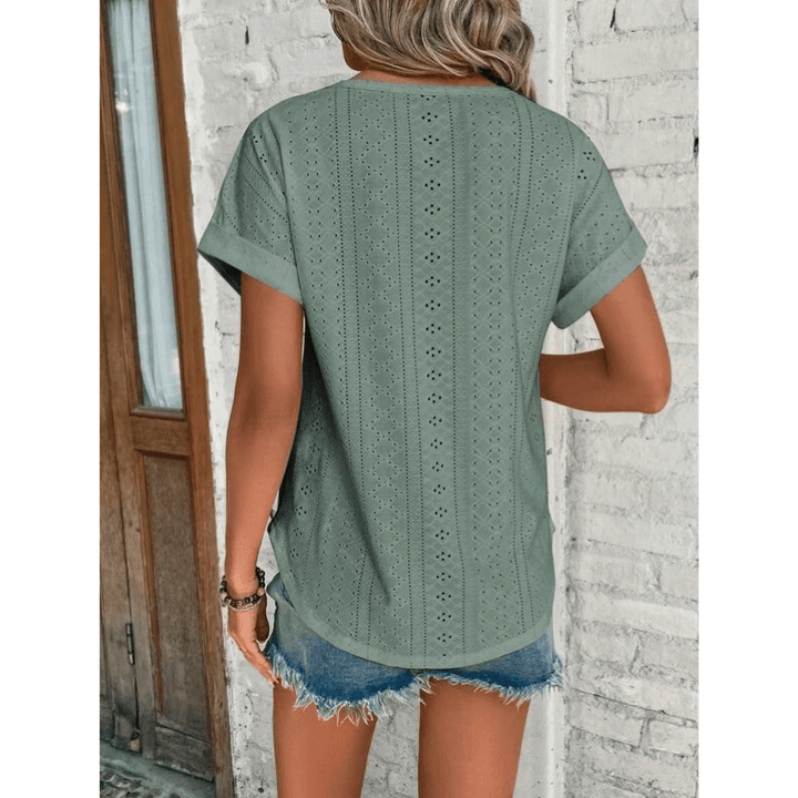 Female model showing relaxed fit embroidered blouse, back view
