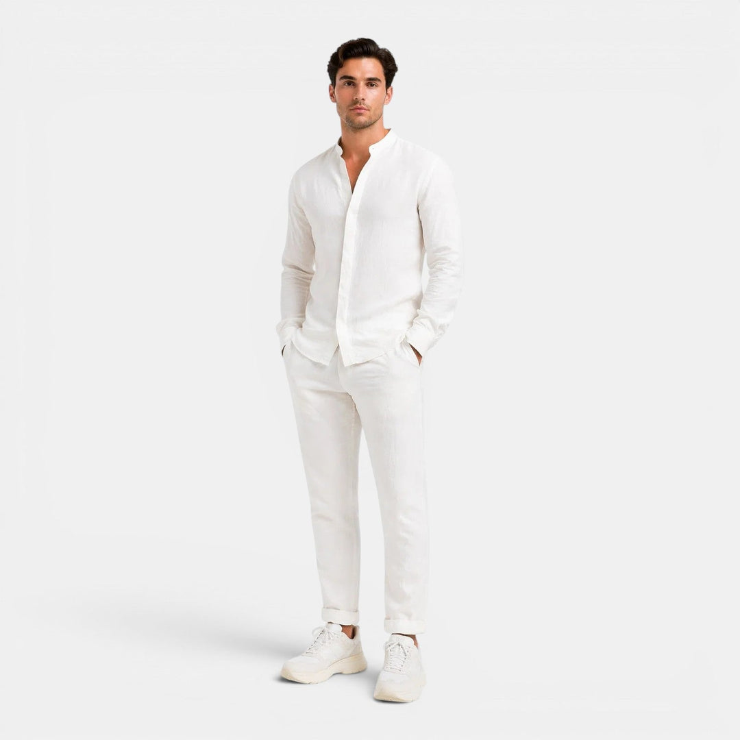  Man wearing a casual coordinated outfit with a plain background.