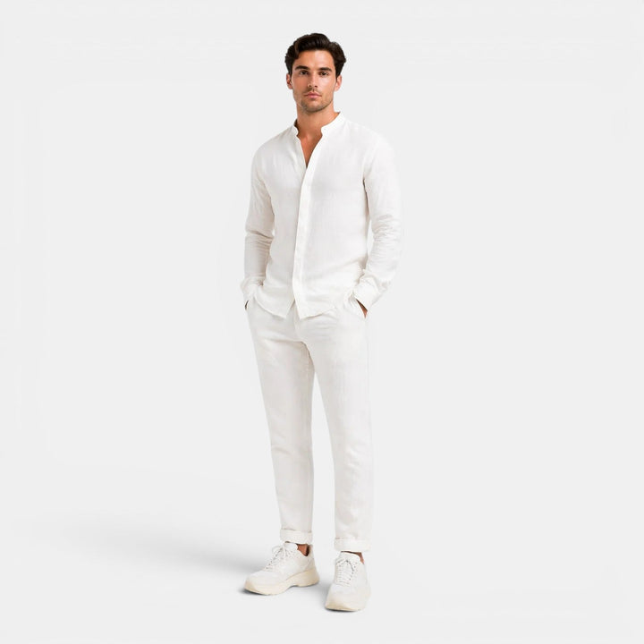 Man wearing a casual coordinated outfit with a plain background.