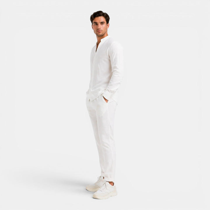  Male model presenting a relaxed warm-weather clothing set on a plain background.