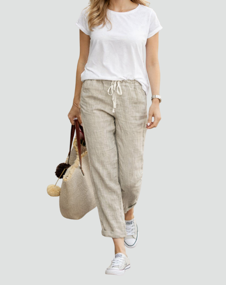 Female wearing relaxed-fit linen trousers with a drawstring waist on a plain background.