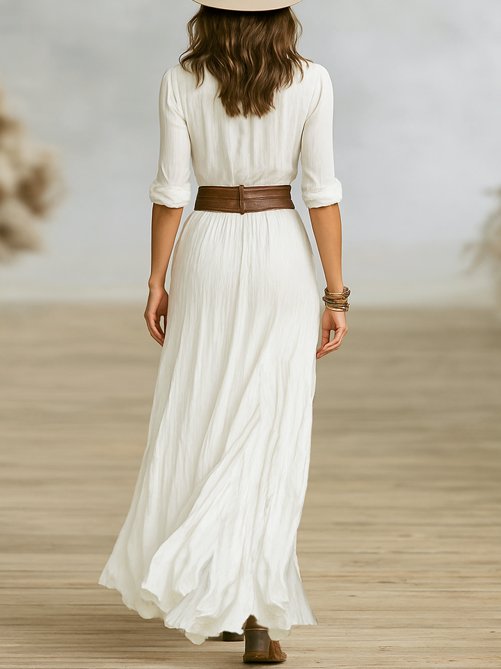 Women’s long dress with soft drape on a plain background.