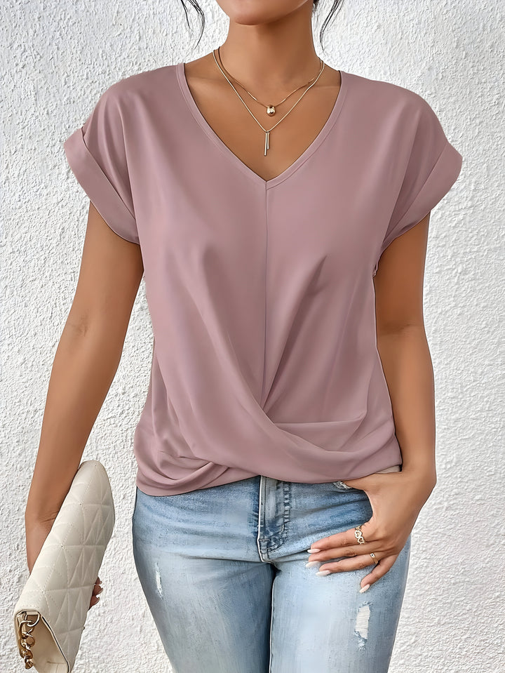 Women’s twist front V-neck top with model on a plain background.