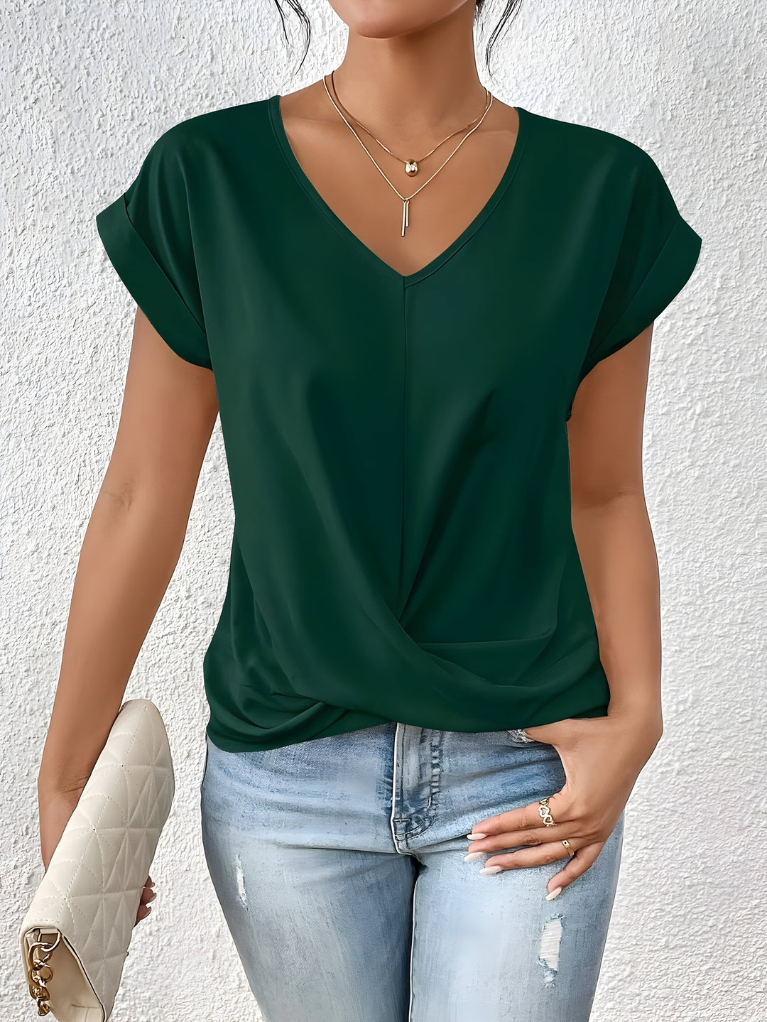 Versatile women’s V-neck twist top styled with model on plain background.