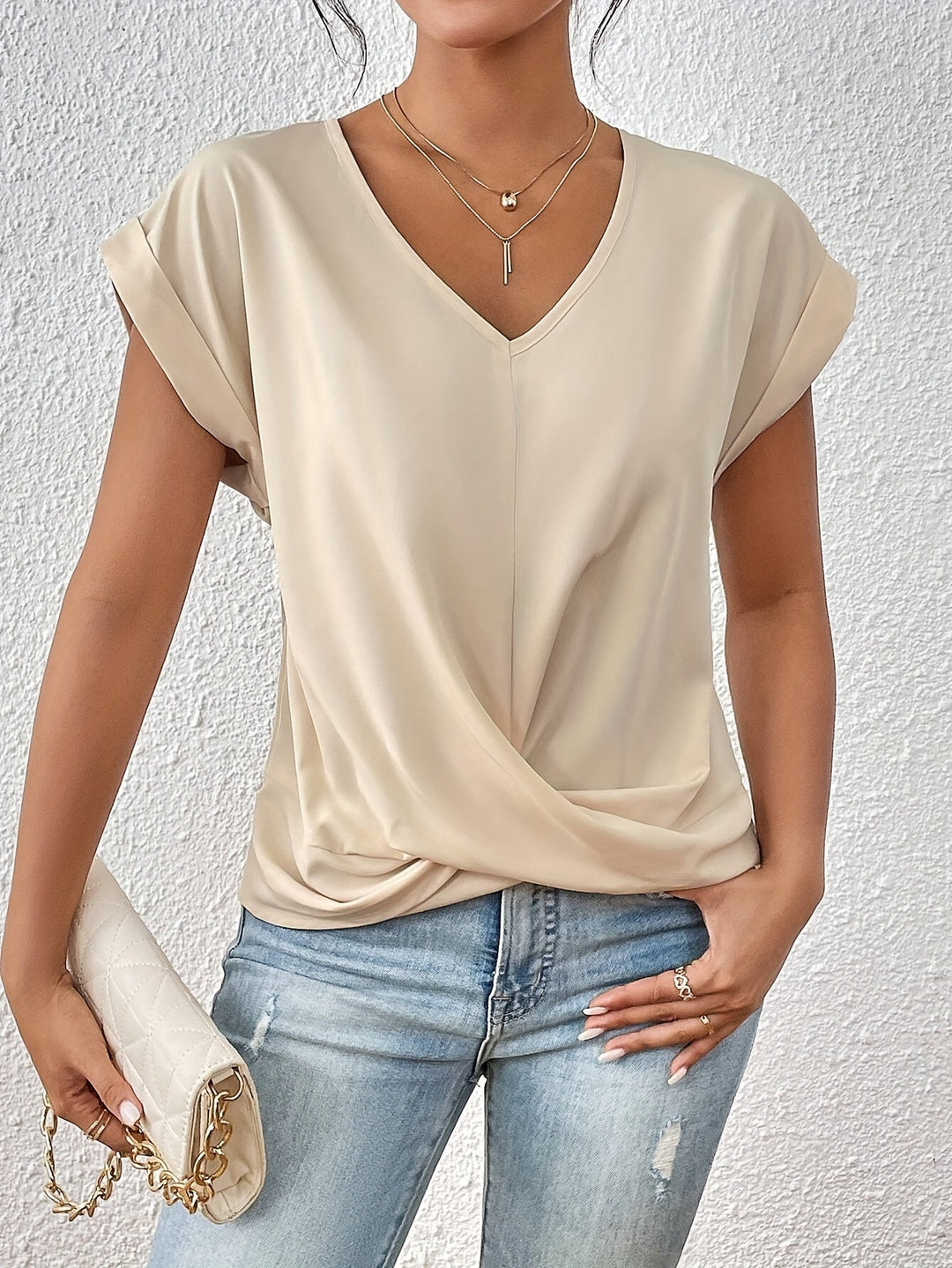 Chic women’s twist front V-neck top displayed with model on clean background.