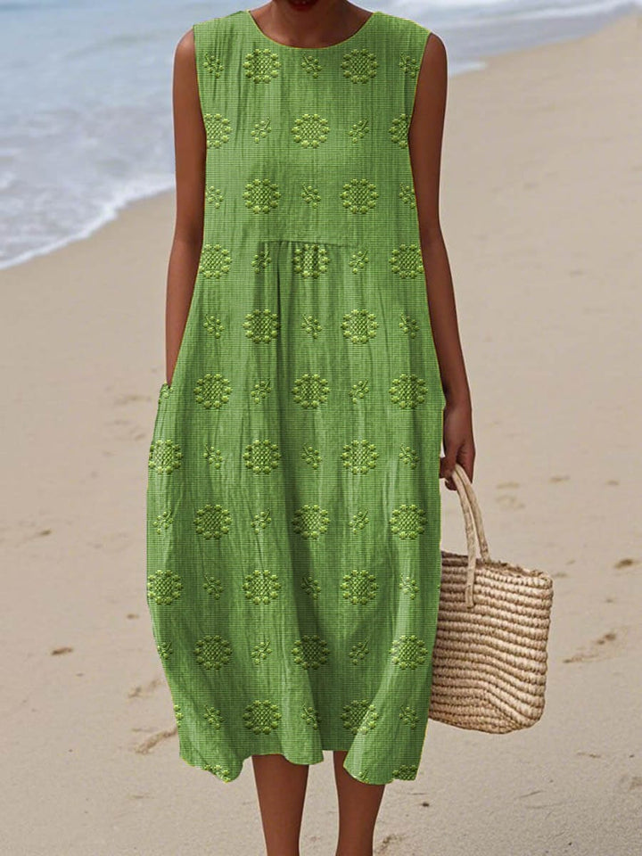 Model wearing embroidered dress front view plain background full body