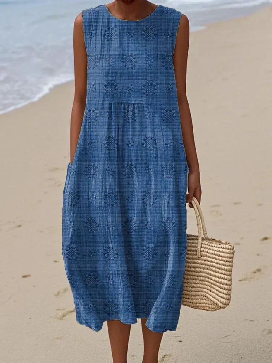 Model standing side angle showing flowy dress plain background view