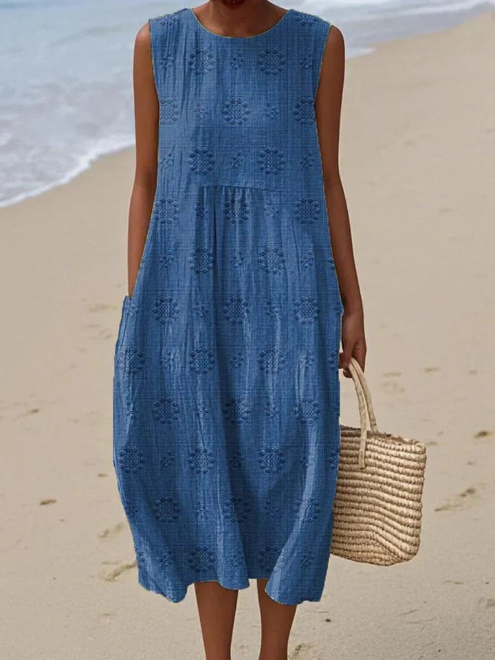 Model standing side angle showing flowy dress plain background view