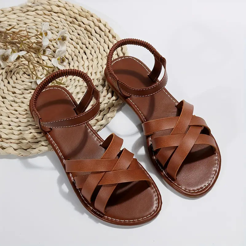 Top angle view of sandals worn by foot model beige background