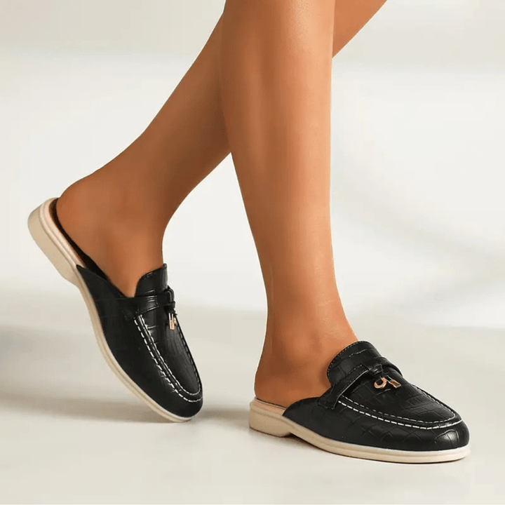 Elegant flat displayed on foot, plain beige background image.