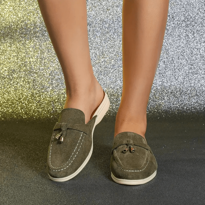 Close view foot wearing green slip-on everyday casual shoes